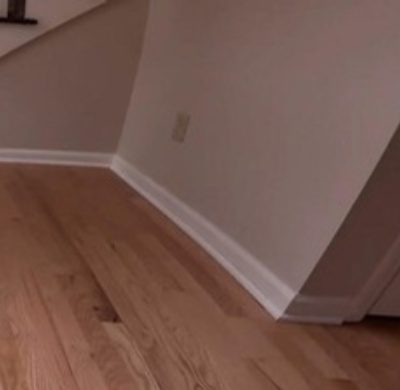 Light natural oak floor with white baseboards along a curved wall by The Hardwood Guys, serving Fairfield, CT